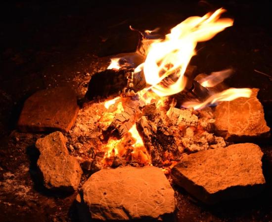 Photo showing replica rock art etchings by firelight. Source: Needham et al. - PLOS ONE / CC-BY 4.0