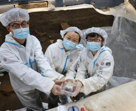 Researcher Li Nan, from Peking University, pictured with her team, holding the foot amputation evidence that was subjected to biomedical analysis. Source: South China Morning Post