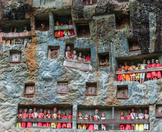 A traditional burial site in Tana Toraja, whose culture is known for elaborate funeral rituals. Source: fabio lamanna / Adobe Stock 