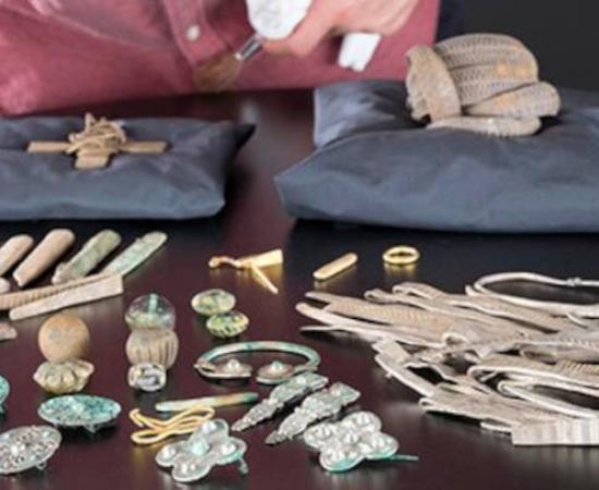 Senior Curator at National Museums Scotland, Martin Goldberg, looking at objects from the Viking age Galloway Hoard.