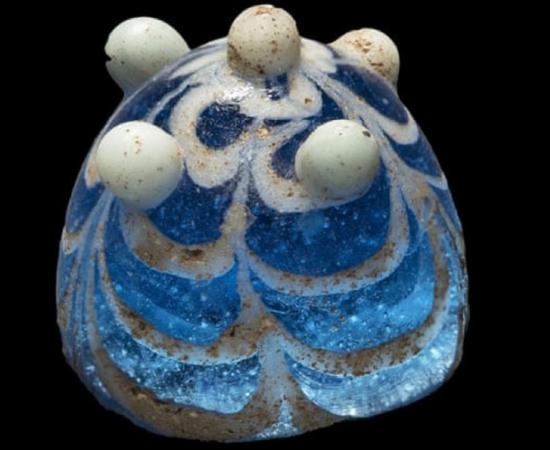 The glass artifact thought to be a Viking game piece discovered in Lindisfarne. Source: Jeff Veitch / Durham University.