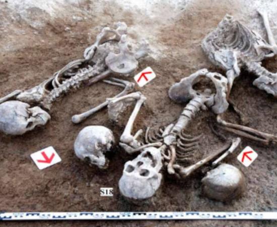 Battered skeletons plus extra unattached skulls excavated from site near Great Wall of China in 2009.