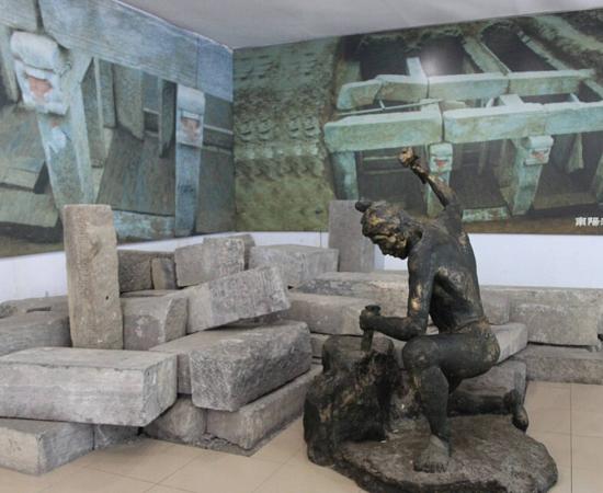 Collection of Han Dynasty tomb bricks, featuring statue of Han stonecutter, on display at Nanyang Museum of Han Dynasty Stone Carving, Henan Province, China