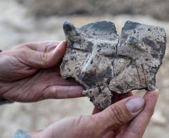 The mysterious ceramic fragment with the horned face image found in a village in Poland.                 Source: Lukasz Gagulski / Science in Poland