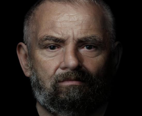 Digital reconstruction of a middle-aged man with close-cropped graying hair and a graying beard