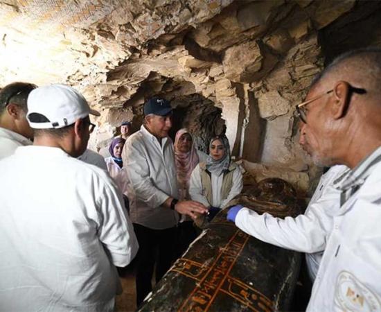 Egyptian officials and archaeologists inspect one of the newly uncovered coffins at Dra Abu El-Naga,