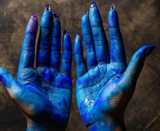Representative image of hands covered with Maya blue pigment. Source: Generated with Adobe Firefly