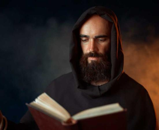 Medieval monk praying with a Bible and a rosary.	Source: Nomad_Soul / Adobe Stock