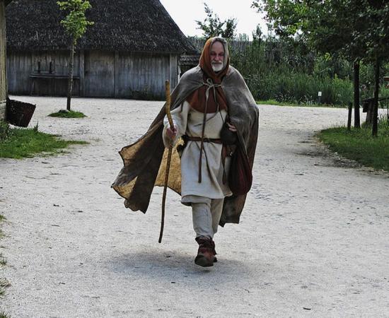 A reenactor dresses as a medieval pilgrim. 