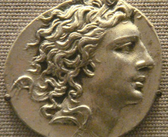 A coin showing the profile of a young king with long, windswept hair