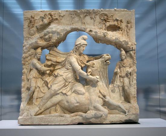 A marble relief showing the Roman god Mithras in a cap kneeling on a bull and slaying it