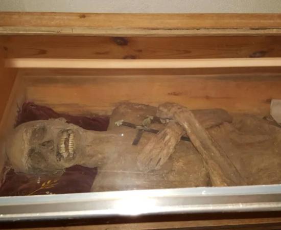The mummy of the 'air-dried chaplain' in his coffin in the church crypt of St. Thomas am Blasenstein, Austria.
