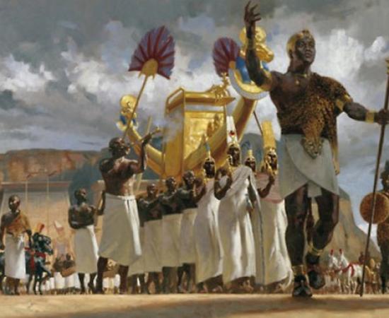Nubian King leads his queens through a crowd during a festival 
