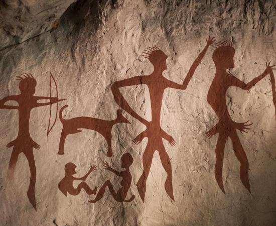 Reproduction of a prehistoric cave painting showing hominins hunting
