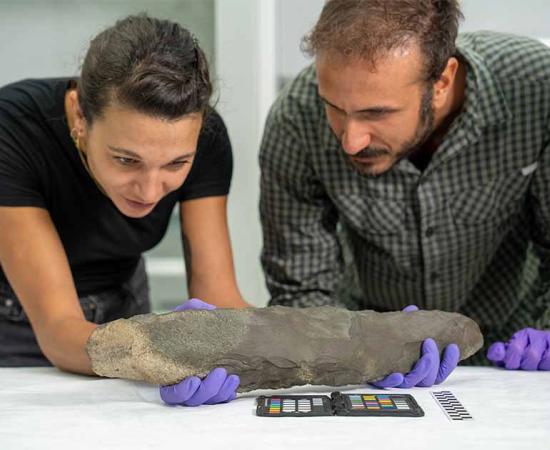 Dr Omer Aksoy and Giulia Edmond measuring the prehistoric hand axes. Source: The Royal Commission for AlUla (RCU)