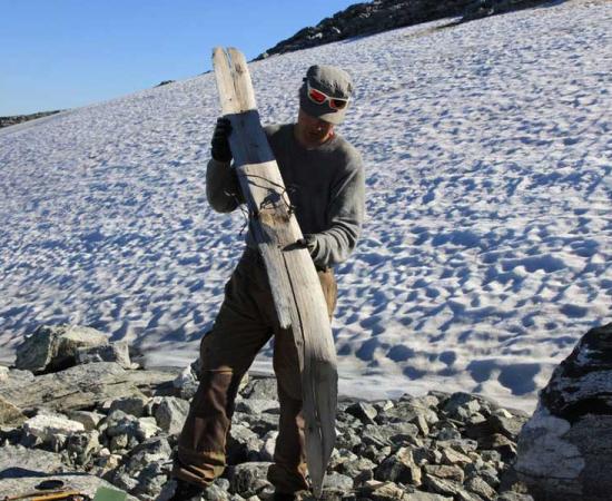 Runar Hole holding the Digervarden prehistoric ski found in Norway.                   Source: Aud Hole / secretsoftheice.com