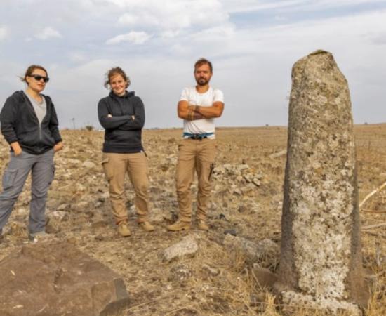 Archaeologists at a re-erected Roman milestone on the Golan Heights Roman highway.