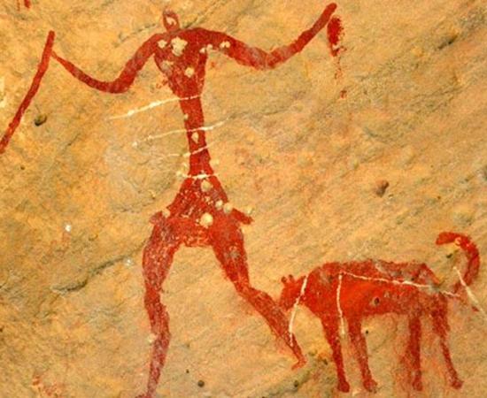 A rock painting possibly depicting a person with a dog. 