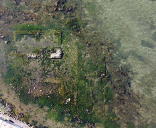 Aerial view of Lake Fusaro and the ruins of the Roman villa visible at the surface.