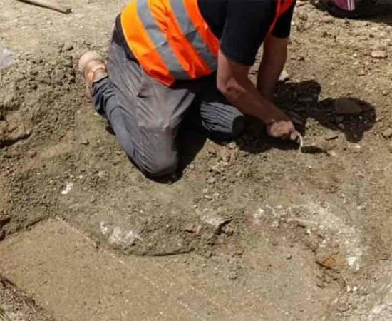 An archaeologist uncovers the indoor pool in the Roman villa, the first such find in the area. Source: Albania’s National Institute of Cultural Heritage / Facebook.