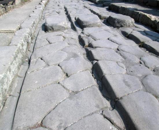 The passage of carts over decades could cause ruts (like the one shown), particularly in high-traffic areas of Pompeii.