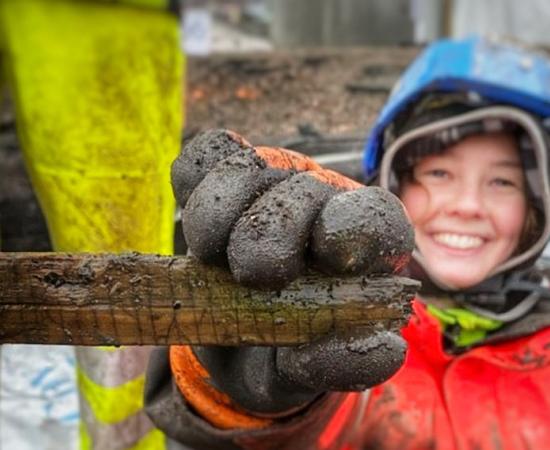 Archaeologist Ingeborg Hornkjøl unearthing an ancient stick with runic writing. Source: Tone Bergland / NIKU