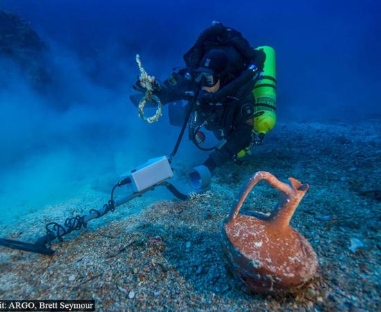 Metal detector survey of the shipwreck area, photo by Brett Seymour. 