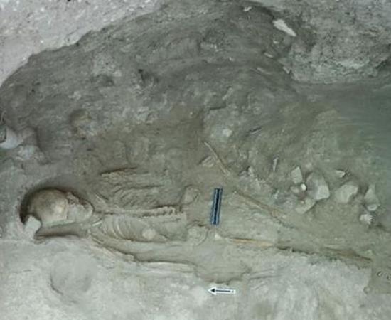 Skeleton of a 30–40 year-old woman with a decorated  ivory button on her chest, from the first tomb