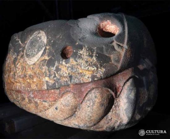 Colorful, stone snake deity head recovered in Mexico City.      Source: LANCIC. UNAM/INAH