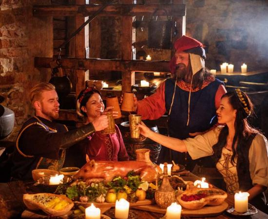 Israeli archaeologists working at the Tel Tsaf site in the Jordan valley have discovered the earliest evidence of social drinking in the Middle East, dating to 5000 BC. This image shows medieval people eating and drinking together in an ancient kitchen interior. 		Source: Nejron Photo / Adobe Stock