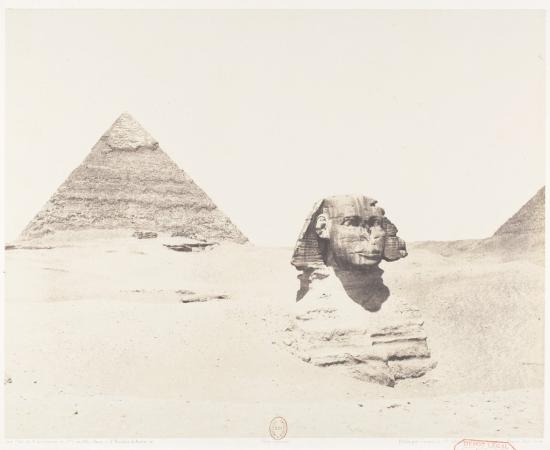 The Great Sphinx of Giza, buried to its shoulders in sand, with Khafre's pyramid behind it, in an 1851–52 photograph by Félix Teynard