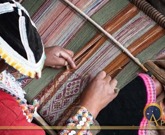 This woman is showing how local textiles are woven. 