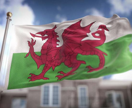 Wales Flag on Blue Sky. 