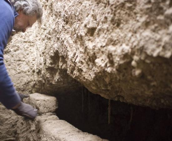 Professor Stuart Tyson Smith opens an intact tomb with the coffined, mummified burial of an elderly woman inside. 