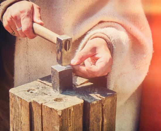 traditional craftsman creates silver money