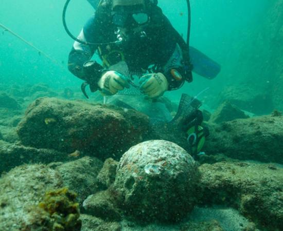 The underwater archaeologists found dozens of cannonballs at the wreck site. 