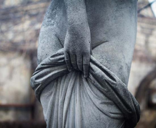 Statue of a woman covering herself. Credit: macondos / Adobe Stock