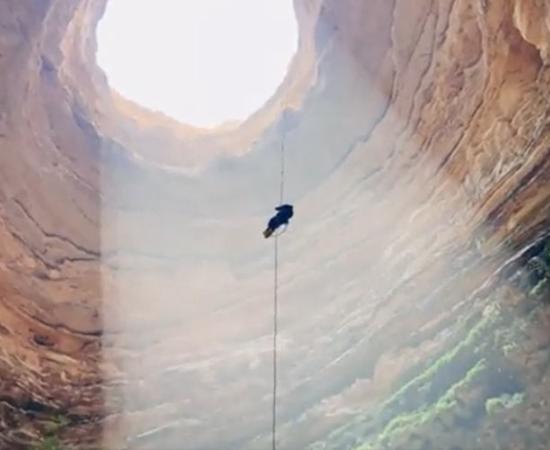 An Omani Caves Exploration Team member about to descend to the bottom of Yemen’s legendary Well of Hell.			Source: Screenshot / OCET Oman