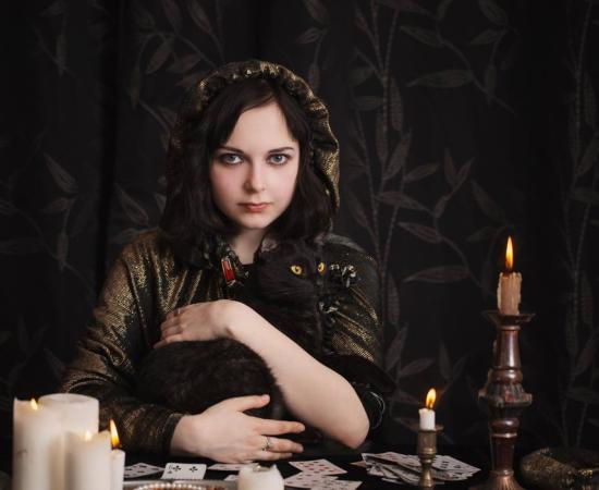 A witch with her cat familiar, a spirit servant to help her with magic.