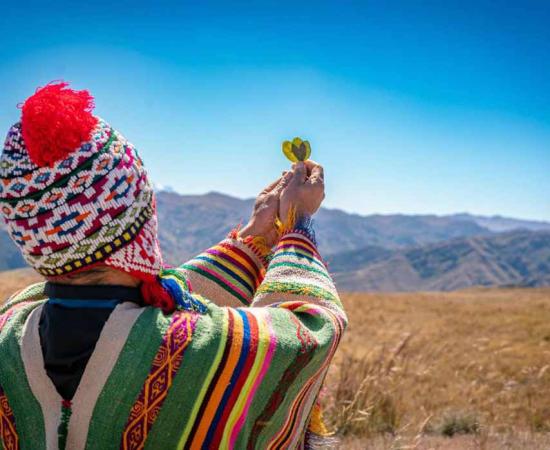 Performing an offering ceremony to Pachamama in the Andes region of Peru. Source: Yuri - Supay / Adobe Stock