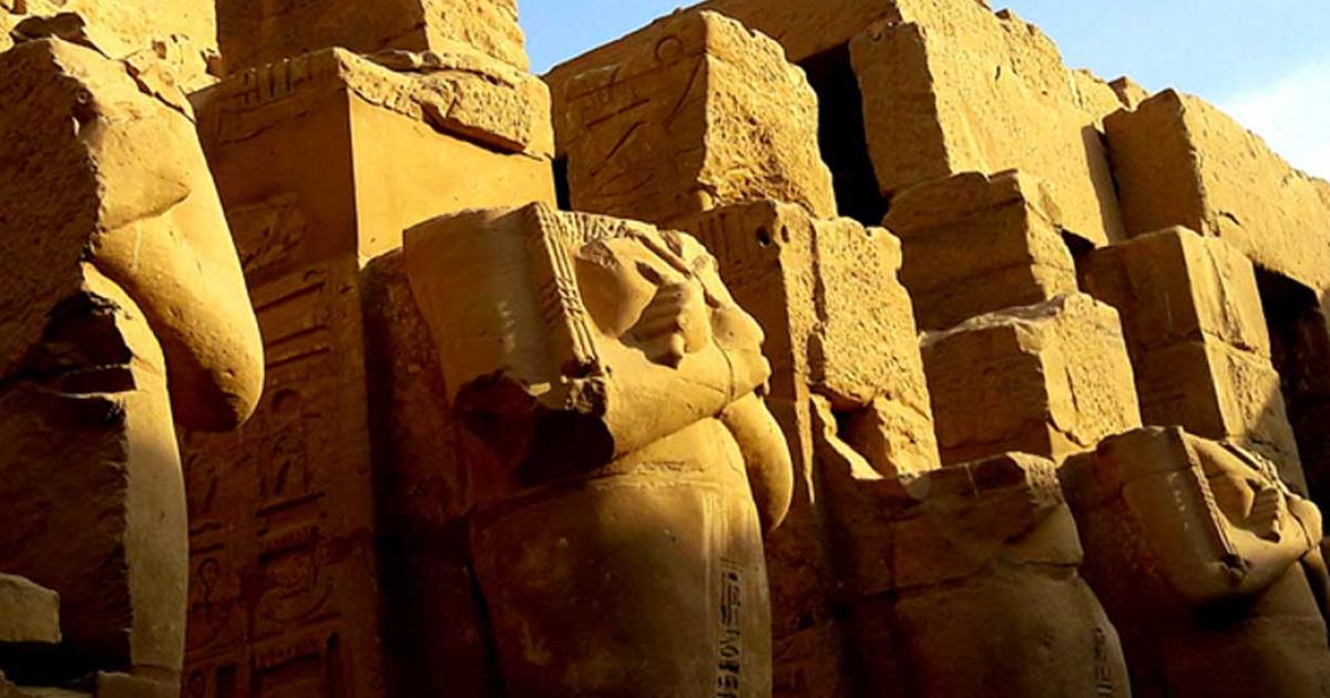 Enormous headless Osiride sculptures of Pharaoh Ramesses III stand in the colonnade of the king's Barque Chapel south of the second pylon at Karnak Temple; design by Anand Balaji 