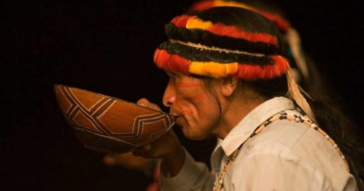 An indigenous person of Peru taking traditional medicine.