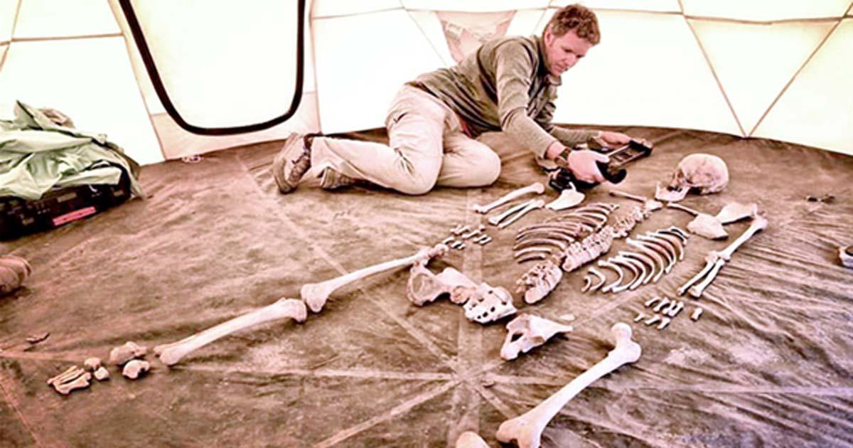 Researcher and filmmaker Jake Norton photographs a 1,200-year-old skeleton from Samdzong, Nepal. 