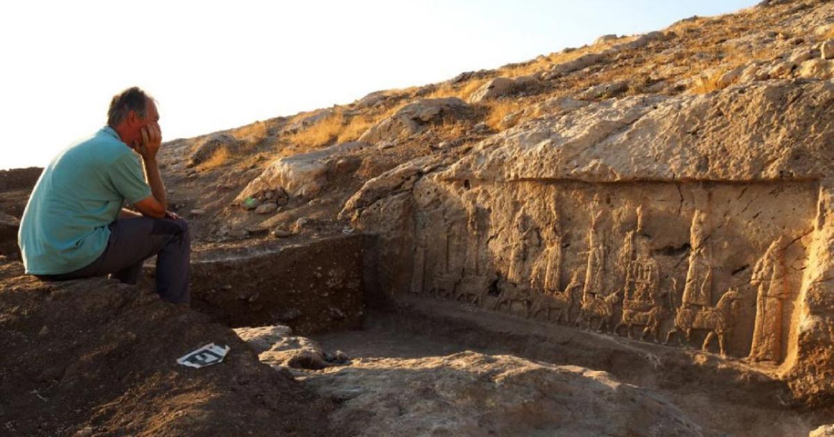 The leader of the excavation, archaeologist Daniele Morandi Bonacossi, and one of the Assyrian relief carvings unearthed in the northern Kurdistan region of Iraq.    Source: Alberto Savioli / Land of Nineveh Archaeological Project / University of Udine