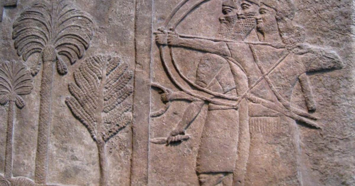 Relief, circa 728 B.C., depicting an Assyrian warrior holding a large shield to protect two archers taking aim, from the Central Palace in Nimrud and now in the British Museum, London. 