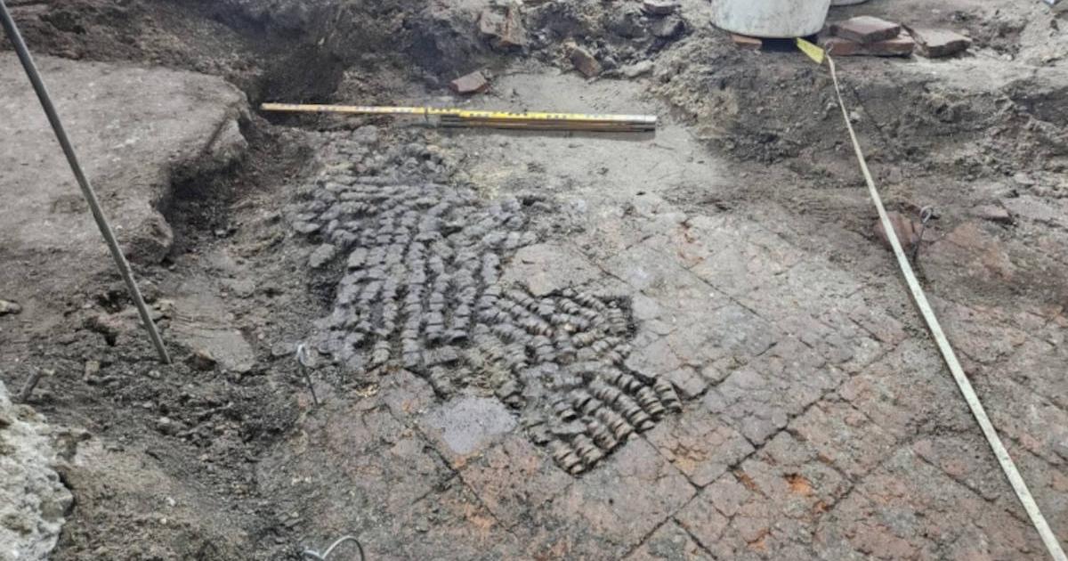 Tile floor patched with cow bones, found during excavations in Alkmaar city center.