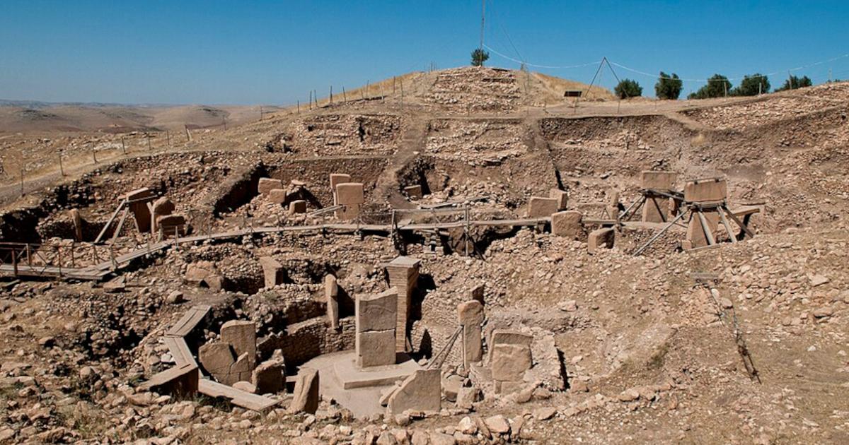 Göbekli Tepe's excavated stone enclosures and surrounding hill in southeastern Turkey.   