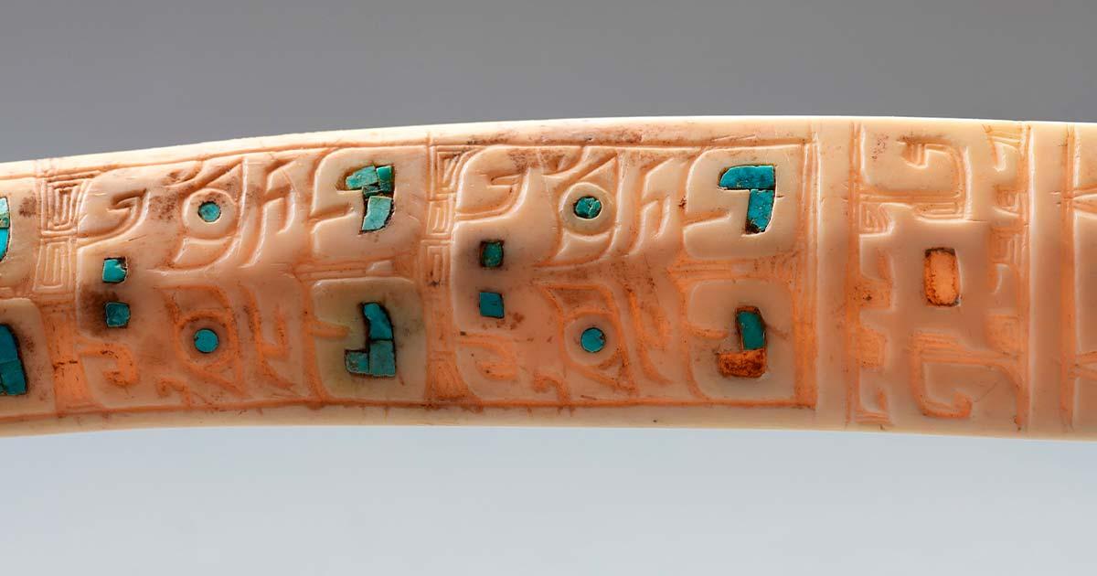 A bone carved with designs that depict a catfish and inlaid with pieces of turquoise. (Image credit: Shaanxi Academy of Archaeology)