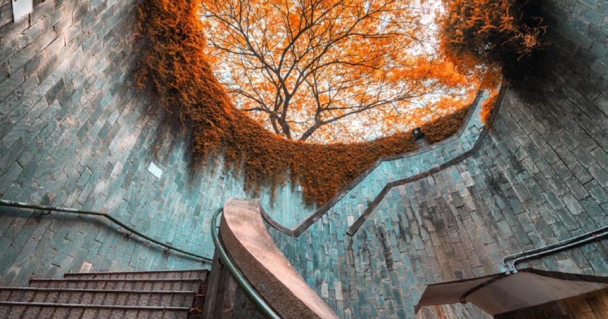 Spiral staircase of underground crossing in tunnel at Fort Canning Park, Singapore Source: (martinhosmat083/ Adobe Stock)