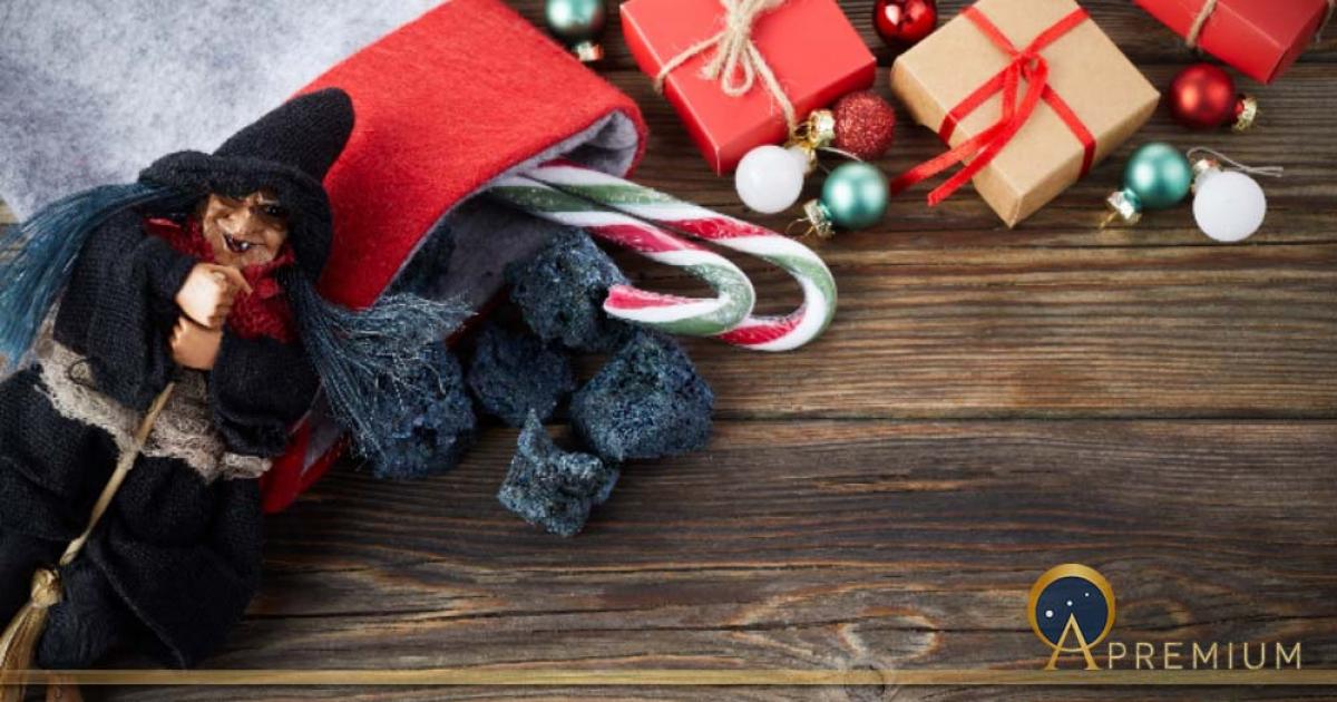 The Befana with sweet coal and candy on wooden background. Italian Epiphany day tradition (vetre/Adobe Stock)